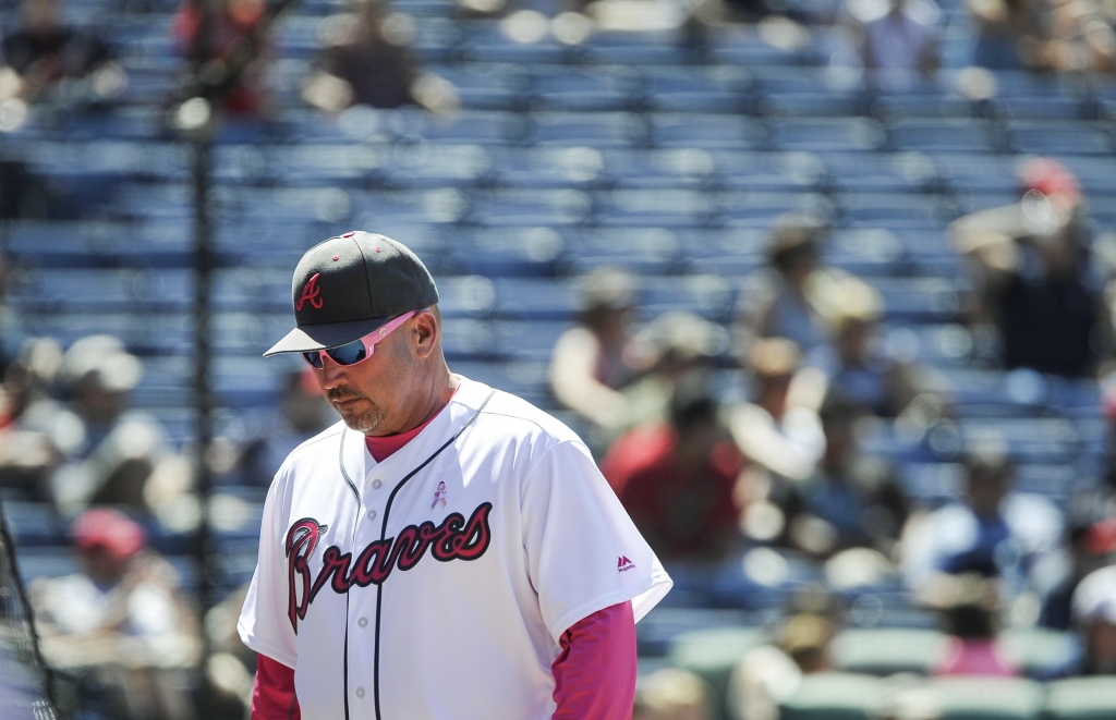Atlanta Braves manager Fredi Gonzalez comes off the field with half-empty stands behind him after discussing a call with an umpire during the eighth inning of a baseball game against the Arizona Diamondbacks, Sunday, May 8, 2016, in Atlanta. (AP Photo/John Amis)