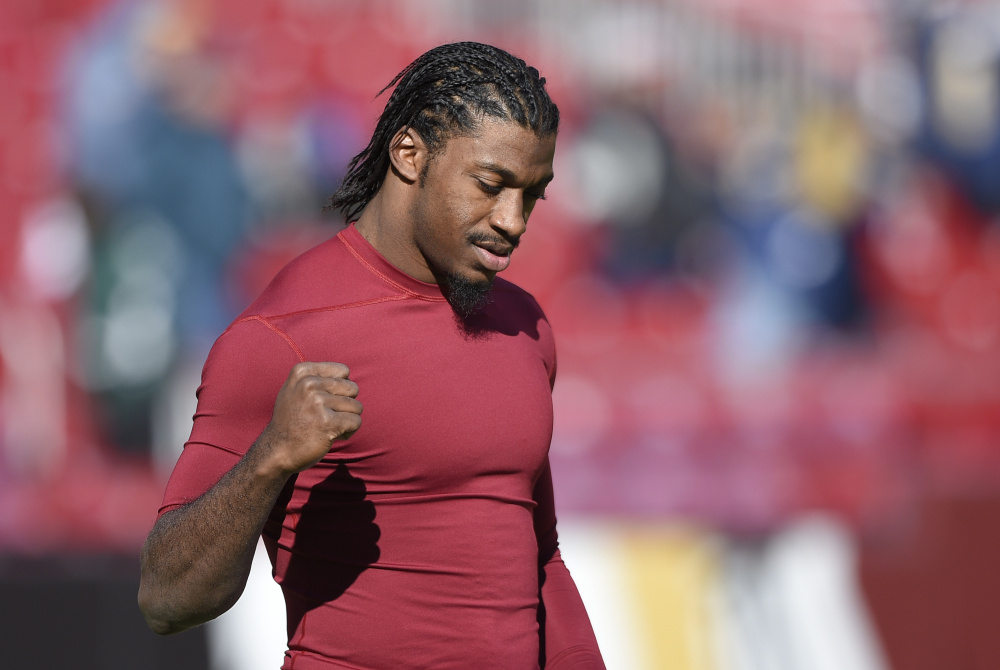 Washington Redskins quarterback Robert Griffin III (10) walks across the field during warms ups before an NFL football game against the St. Louis Rams in Landover, Md., Sunday, Dec. 7, 2014. (AP Photo/Nick Wass) ORG XMIT: NYOTK007