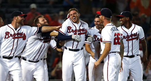 Teammates celebrate after Freeman hit a home run. (AP Photo/Butch Dill)