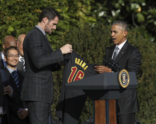 Cleveland Cavaliers forward Kevin Love presents President Barack Obama with the team jersey during a ceremony honoring the 2016 NBA basketball champions, Thursday, Nov. 10, 2016, on the South Lawn of the White House in Washington. (AP Photo/Manuel Balce Ceneta)