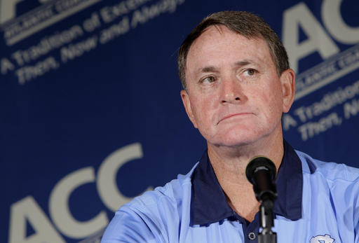 FILE - In this July 25, 2011 file photo, North Carolina coach Butch Davis pauses during interviews at the Atlantic Coast Conference Football Kickoff in Pinehurst, N.C. Davis was hired Monday, Nov. 14, 2016, as the new coach at FIU. (AP Photo/Gerry Broome, File)
