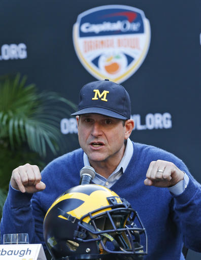 Michigan head coach Jim Harbaugh gestures as he talks about wanting to see Florida State traditions such as "Renegade," the war horse, the spear and the tomahawk chant, as he answers questions during a news conference, Wednesday, Dec. 7, 2016 in Hollywood, Fla. Michigan and Florida State will play each other Dec. 30, during the Orange Bowl in Miami Gardens, Fla. (AP Photo/Wilfredo Lee)