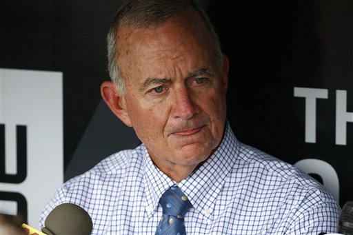 Atlanta Braves President of Baseball Operations John Hart, center, talks with reporters in the dugout before a baseball game against the Pittsburgh Pirates in Pittsburgh, Tuesday, May 17, 2016. (AP Photo/Gene J. Puskar)