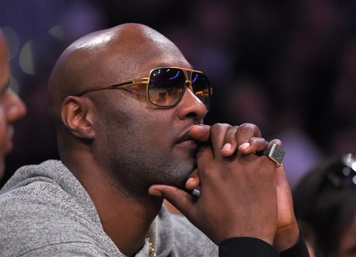 Former Los Angeles Lakers' Lamar Odom watches during the second half of an NBA basketball game between the Lakers and the Miami Heat, Wednesday, March 30, 2016, in Los Angeles. The Lakers won 102-100 in overtime. (AP Photo/Mark J. Terrill)