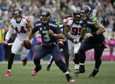 Seattle Seahawks quarterback Russell Wilson (3) scrambles with the ball against the Atlanta Falcons in the second half of an NFL football game, Sunday, Oct. 16, 2016, in Seattle. (AP Photo/Elaine Thompson)
