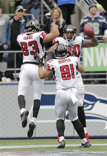 Atlanta Falcons tight end Levine Toilolo, right, celebrates with Austin Hooper 981) and Jacob Tamme (83) after Toilolo scored a touchdown in the second half of an NFL football game against the Seattle Seahawks, Sunday, Oct. 16, 2016, in Seattle. (AP Photo/Stephen Brashear)