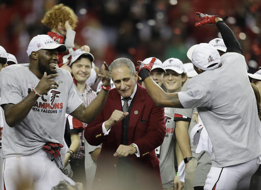 Atlanta Falcons owner Arthur Blank dances with players after the NFL football NFC championship game against the Green Bay Packers, Sunday, Jan. 22, 2017, in Atlanta. The Falcons won 44-21 to advance to Super Bowl LI. (AP Photo/David Goldman)