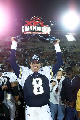 Los Angeles Xtreme quarterback and XFL Player of the Year Tommy Maddox holds the league championship trophy in the air after Los Angeles beat the San Francisco Demons 38-6, April 21, 2001, in Los Angeles.  The XFL, founded by the World Wrestling Federation and jointly owned by NBC folded Thursday, May 10, 2001, after one season.  (AP Photo/Jill Connelly)