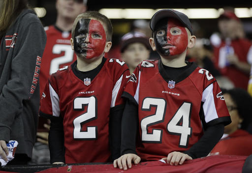Some young Atlanta Falcons fans watch warm ups before the NFL football NFC championship game against the Green Bay Packers Sunday, Jan. 22, 2017, in Atlanta. (AP Photo/Mark Humphrey)