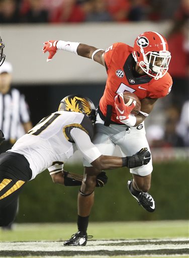 Georgia wide receiver Terry Godwin (5) is stopped by Missouri safety Ian Simon (21) after making a catch in the first half of an NCAA college football game Saturday, Oct. 17, 2015, in Athens, Ga. (AP Photo/John Bazemore)